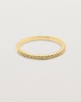 A half band of champagne diamonds set in yellow gold