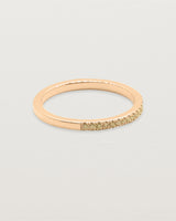 A half band of champagne diamonds set in a rose gold band