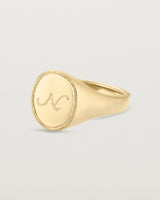 Angled view of the Arden Signet Ring | Millgrain in yellow gold.