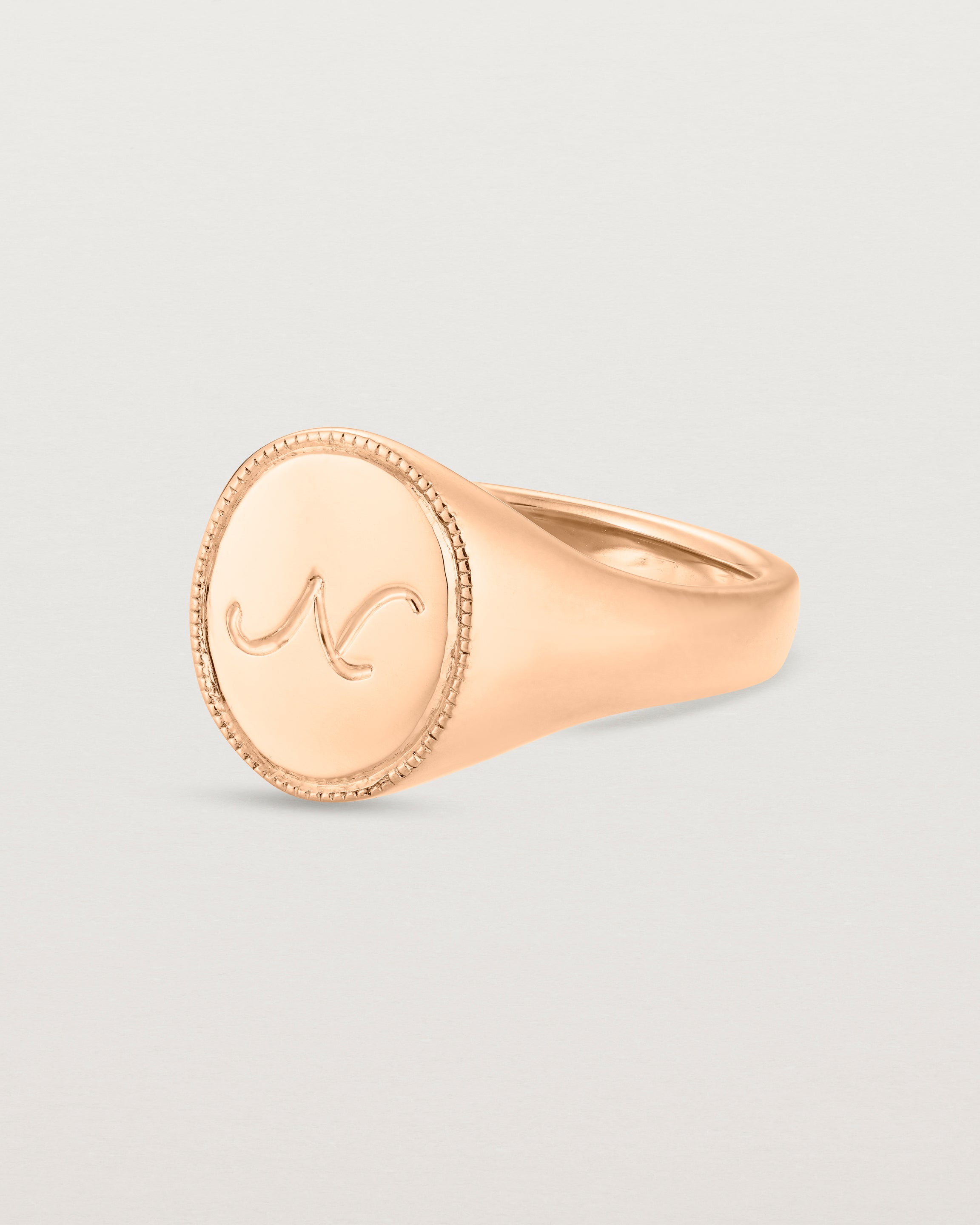 Angled view of the Arden Signet Ring | Millgrain in rose gold.