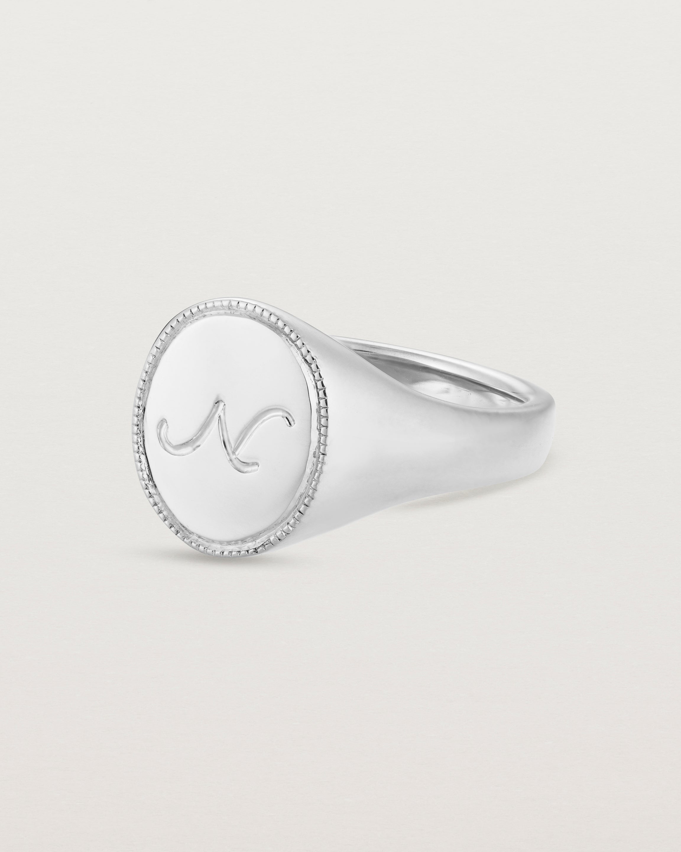 Angled view of the Arden Signet Ring | Millgrain in white gold.