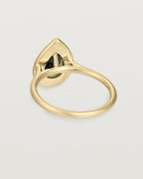 back view pear halo ring featuring a pear cut australian blue sapphire and a halo of white diamonds in yellow gold