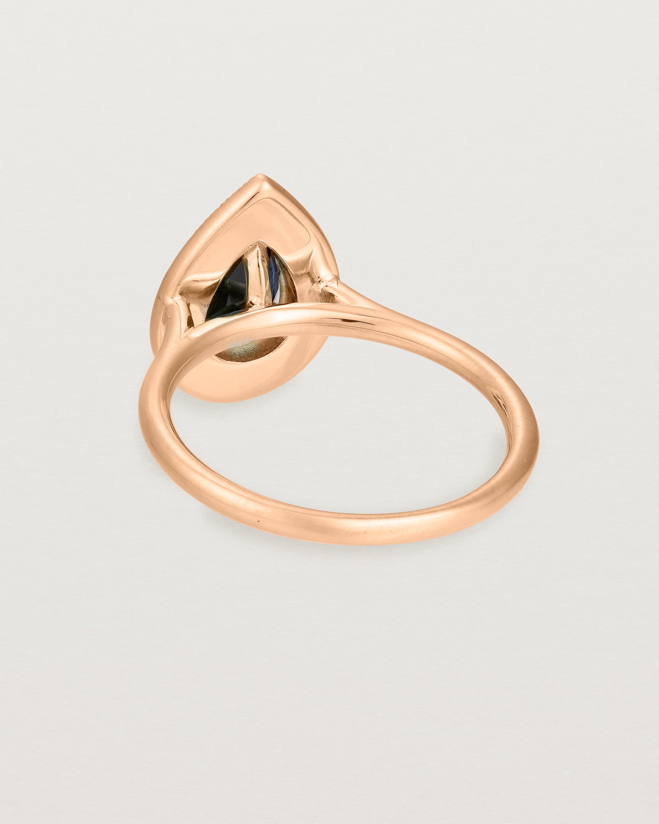 back view pear halo ring featuring a pear cut australian blue sapphire and a halo of white diamonds
