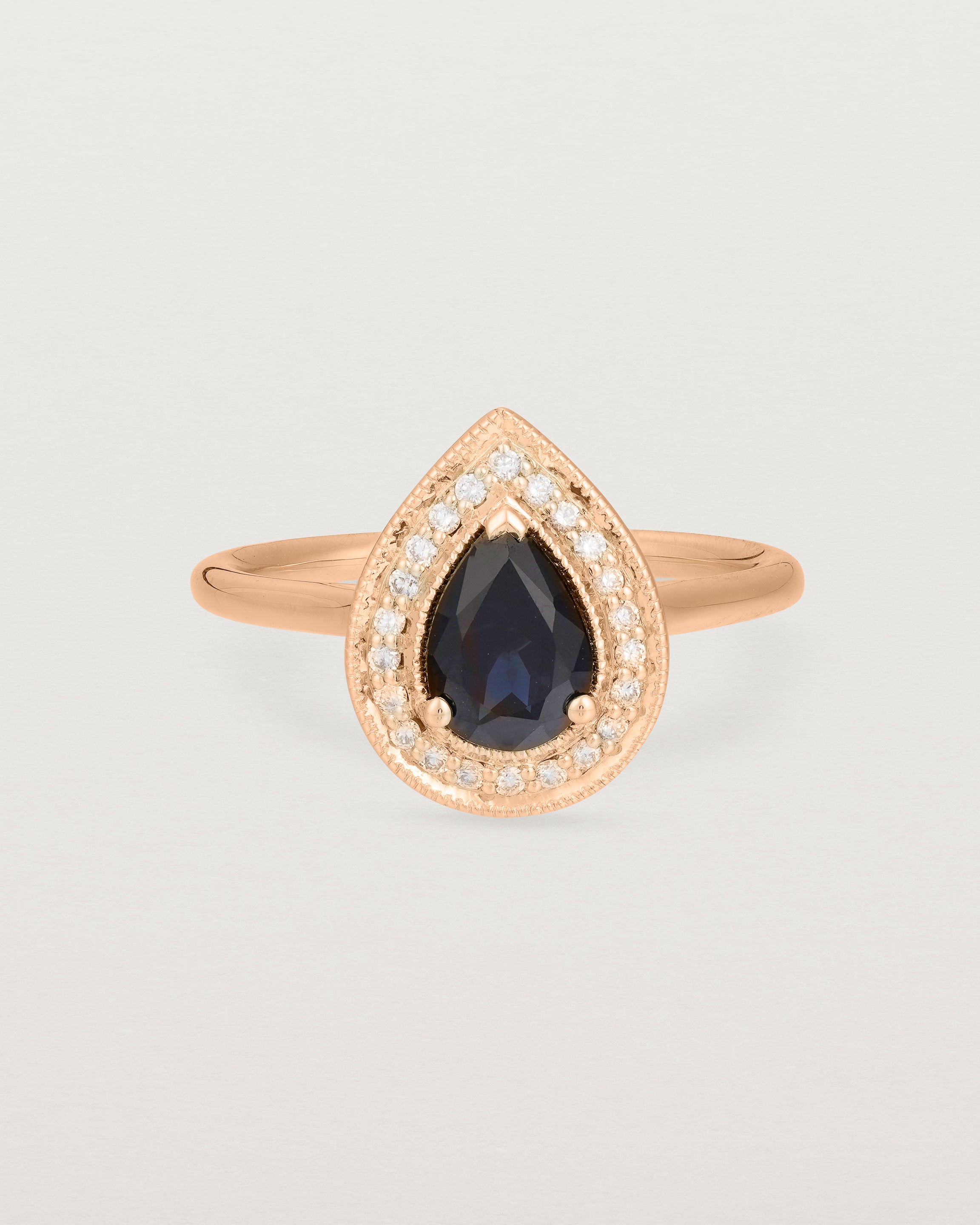 Front view pear halo ring featuring a pear cut australian blue sapphire and a halo of white diamonds