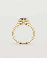 standing view pear halo ring featuring a pear cut australian blue sapphire and a halo of white diamonds in yellow gold