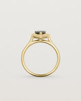 standing view pear halo ring featuring a pear cut australian blue sapphire and a halo of white diamonds in yellow gold