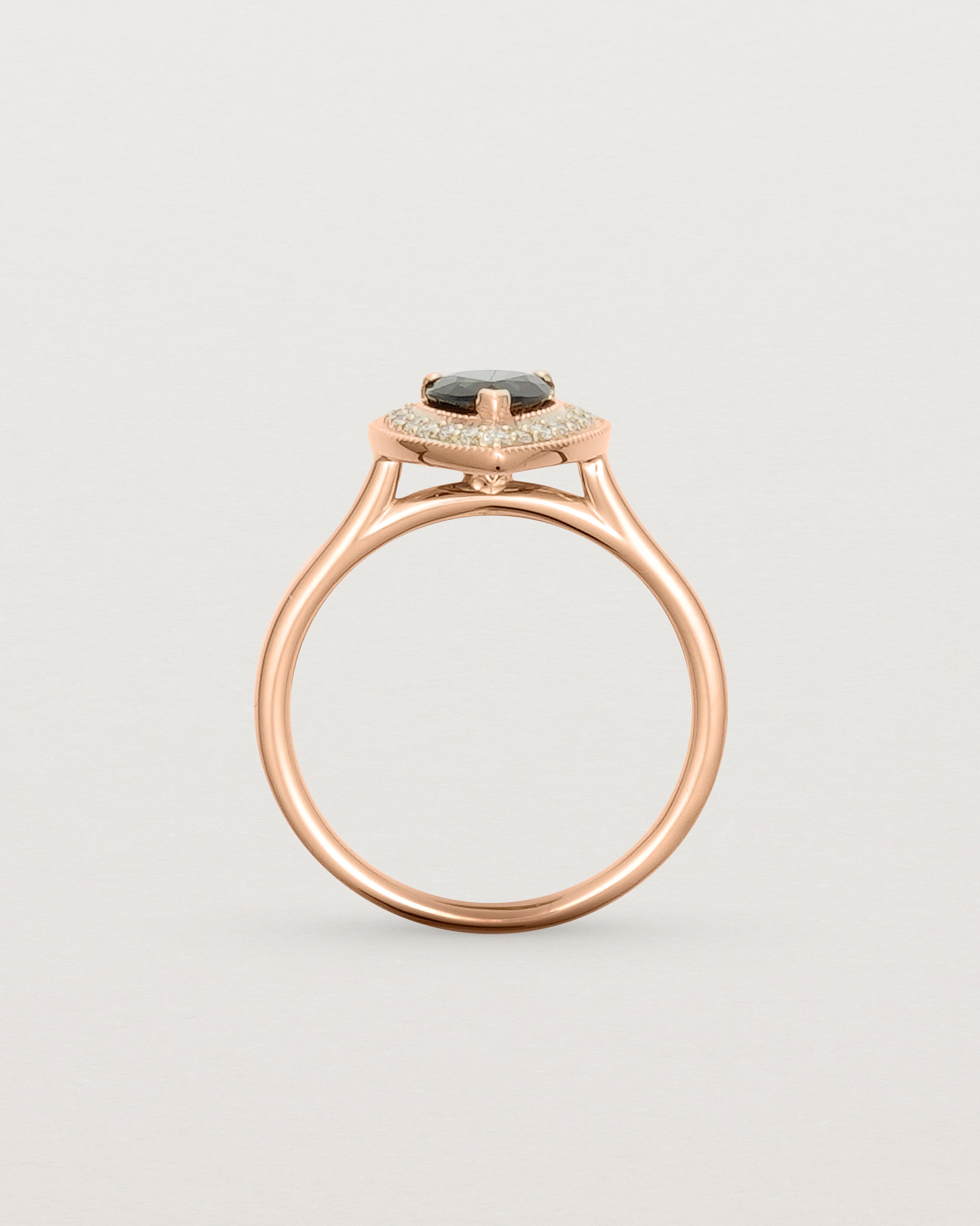 Standing view pear halo ring featuring a pear cut australian blue sapphire and a halo of white diamonds