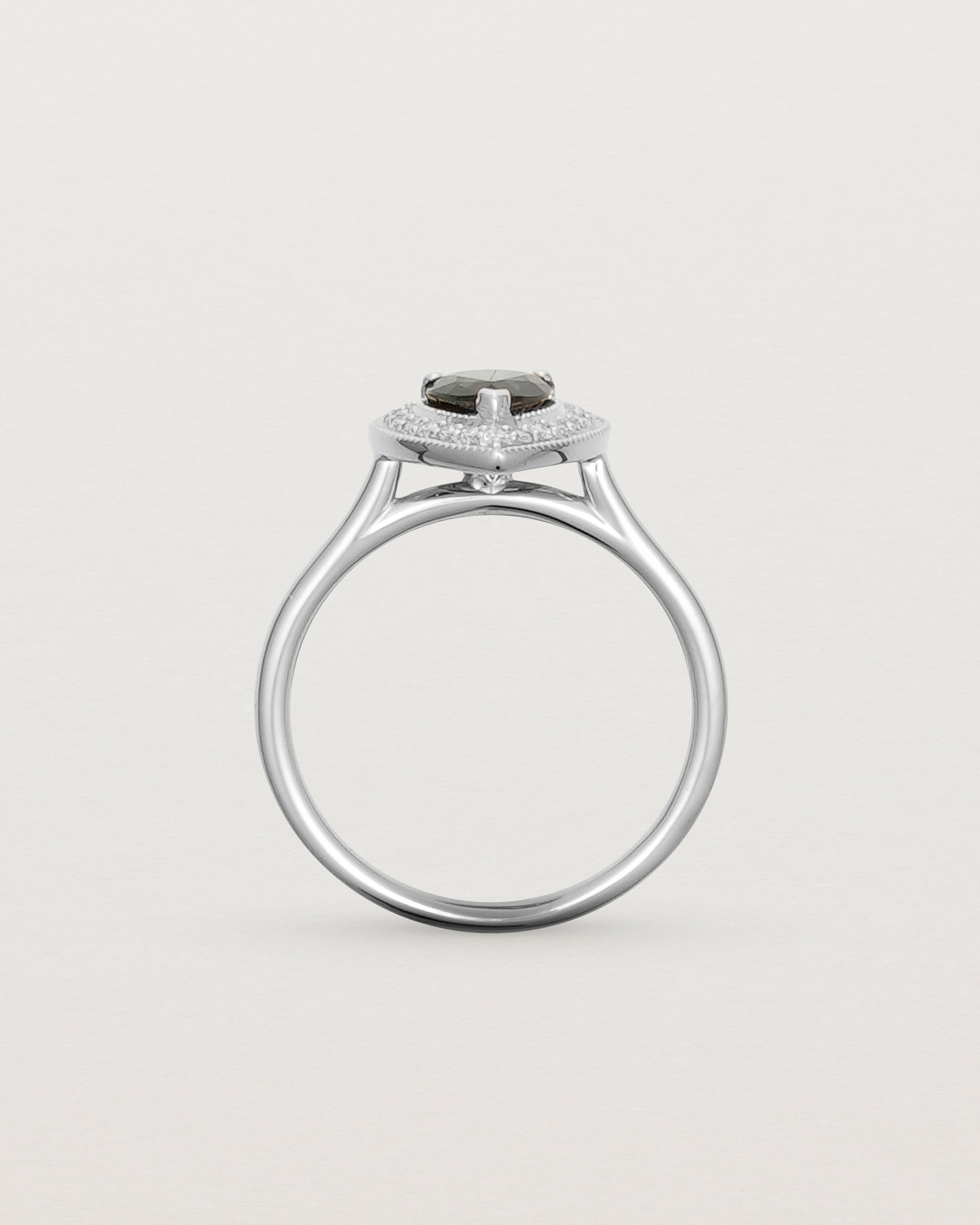 standing view pear halo ring featuring a pear cut australian blue sapphire and a halo of white diamonds in white gold