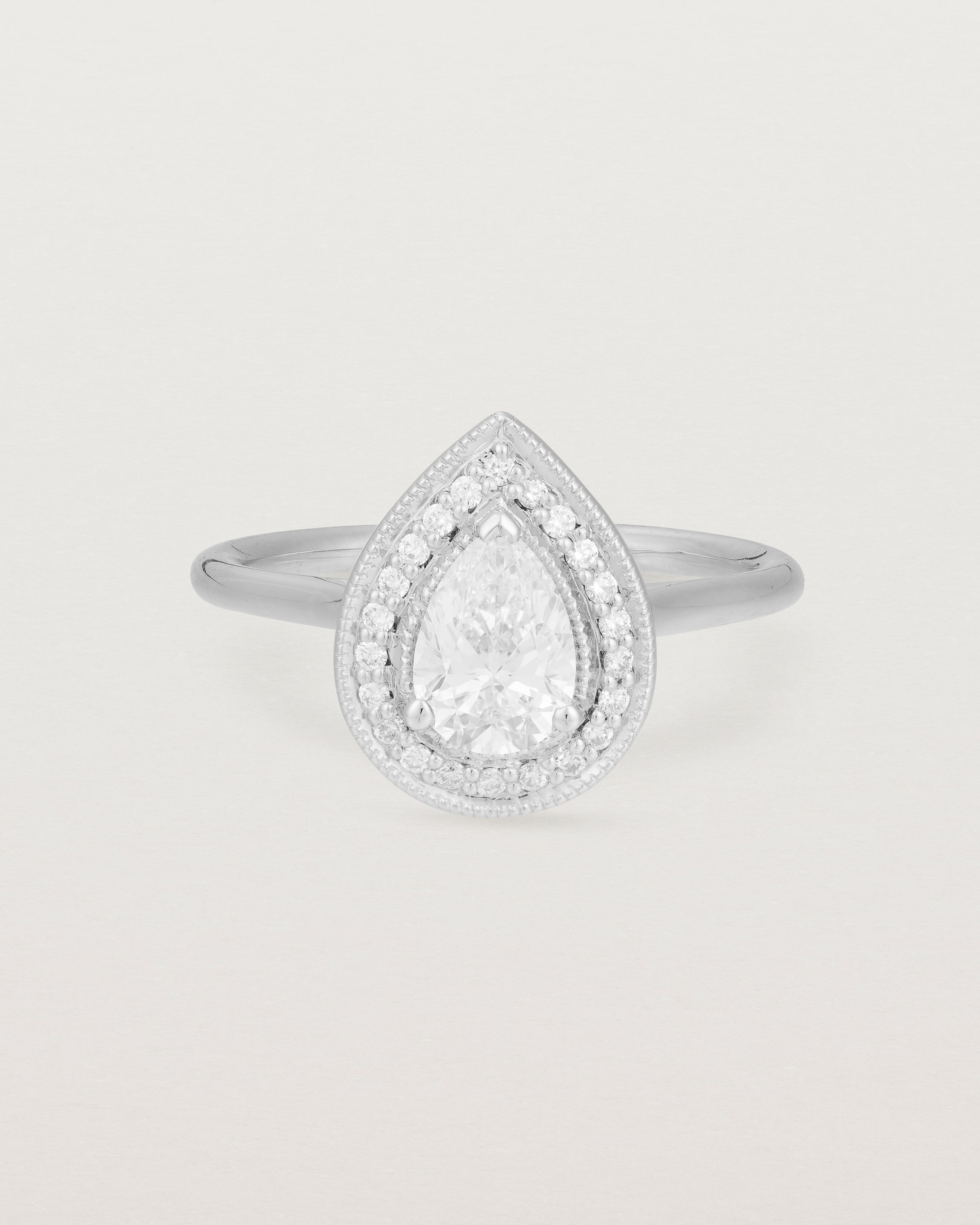 Front view pear halo ring featuring a pear cut clear laboratory grown diamond and a halo of white diamonds in white gold
