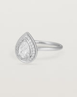Side view pear halo ring featuring a pear cut clear laboratory grown diamond and a halo of white diamonds in white gold
