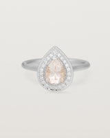 Front view pear halo ring featuring a pear cut pale pink morganite and a halo of white diamonds in white gold