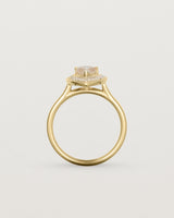 Standing view pear halo ring featuring a pear cut rutilated quartz stone and a halo of white diamonds in yellow gold