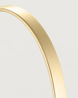 macro shot of the Toujours bangle plain in yellow gold