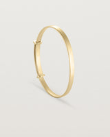 standing image of the Toujours bangle plain in yellow gold