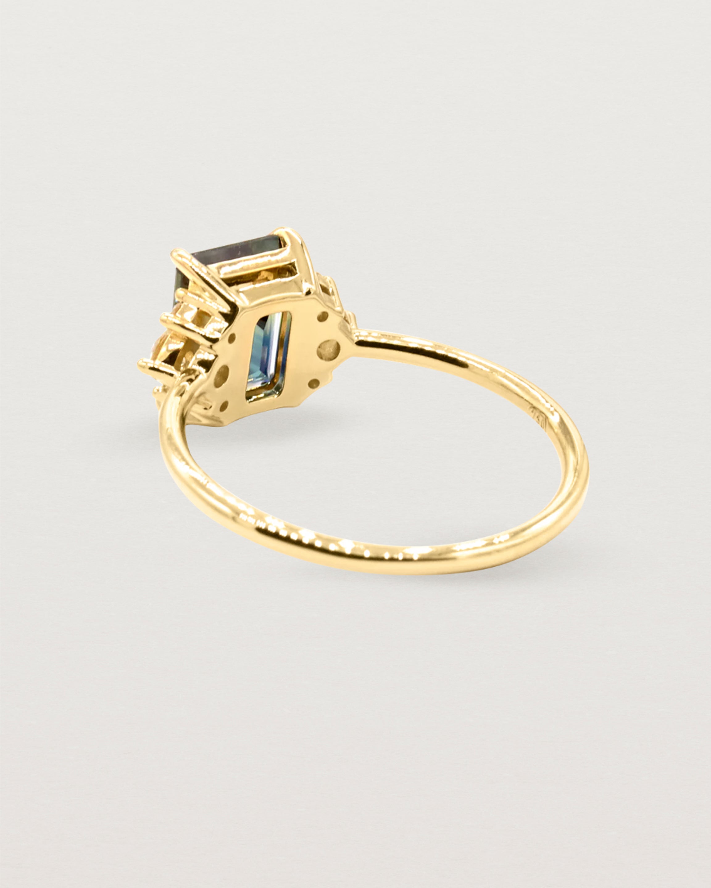 The back view of a cluster ring crafted in yellow gold