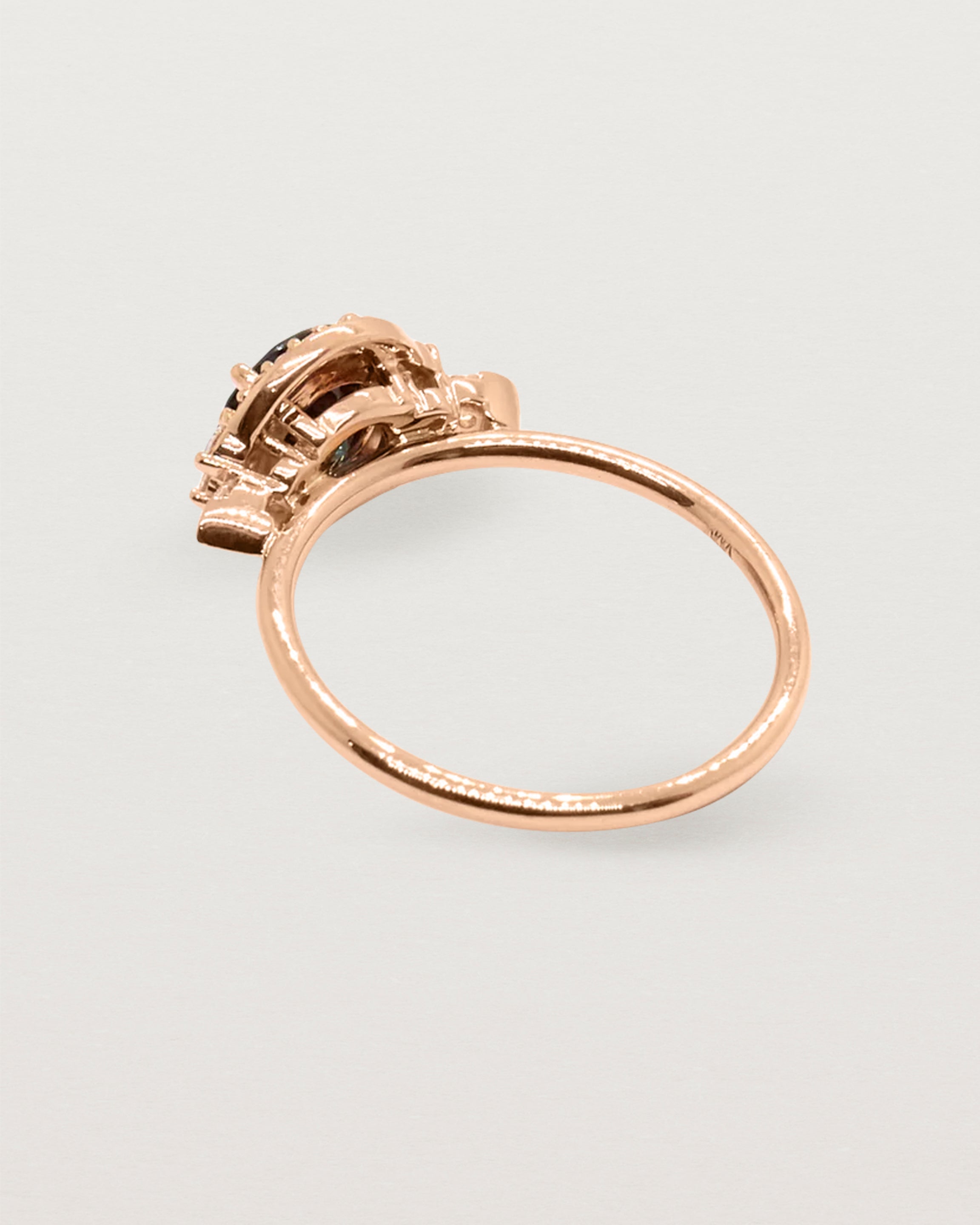The back view of a rose gold cluster ring