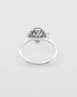 The back view of a white gold halo ring
