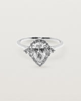 A pear cut diamond, framed by a halo of white diamonds crafted in white gold.