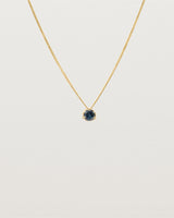 A 3mm blue sapphire is set simply on a fine chain. 