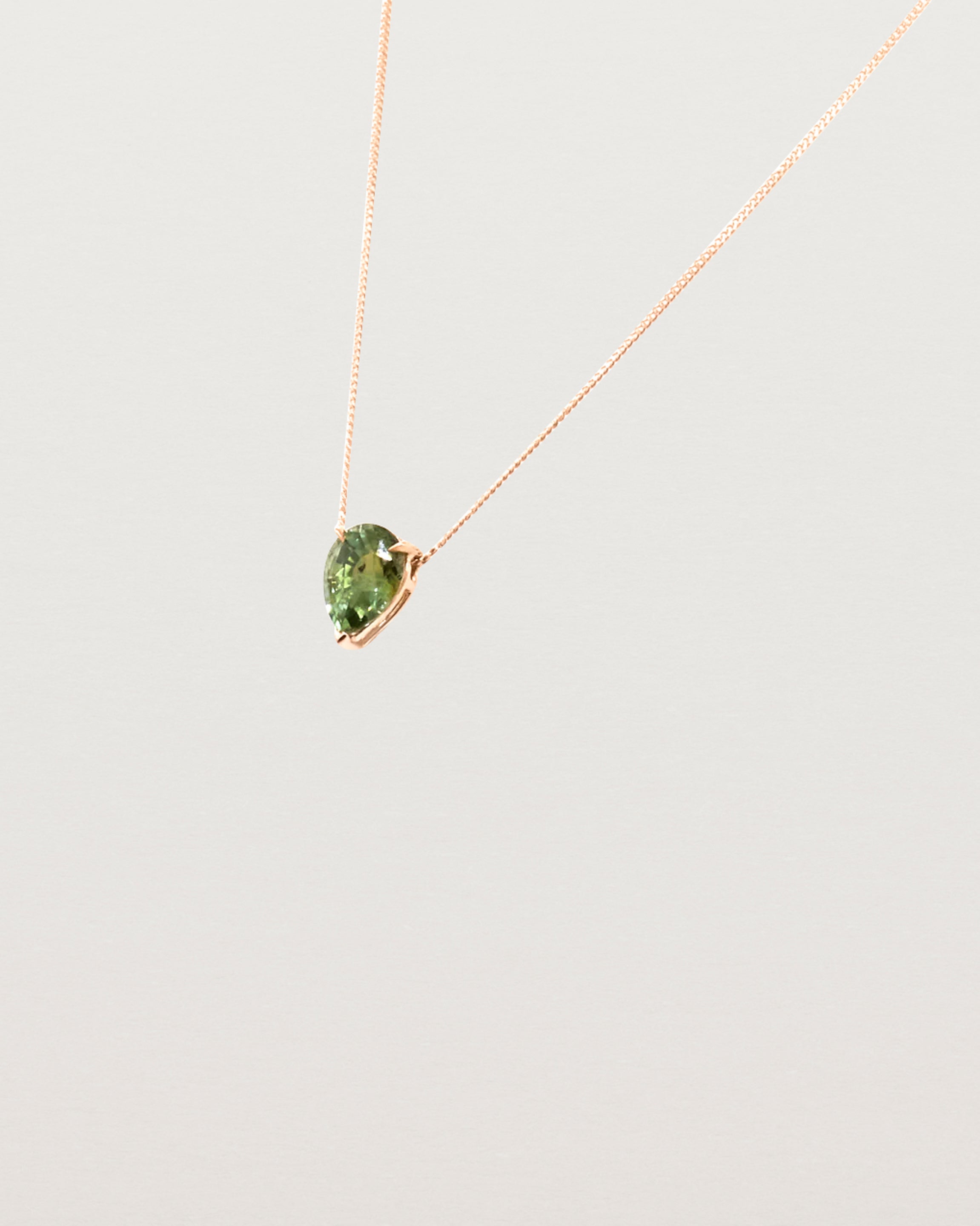 A Madagascan pear sapphire, is set in our classic slider pendant design. 