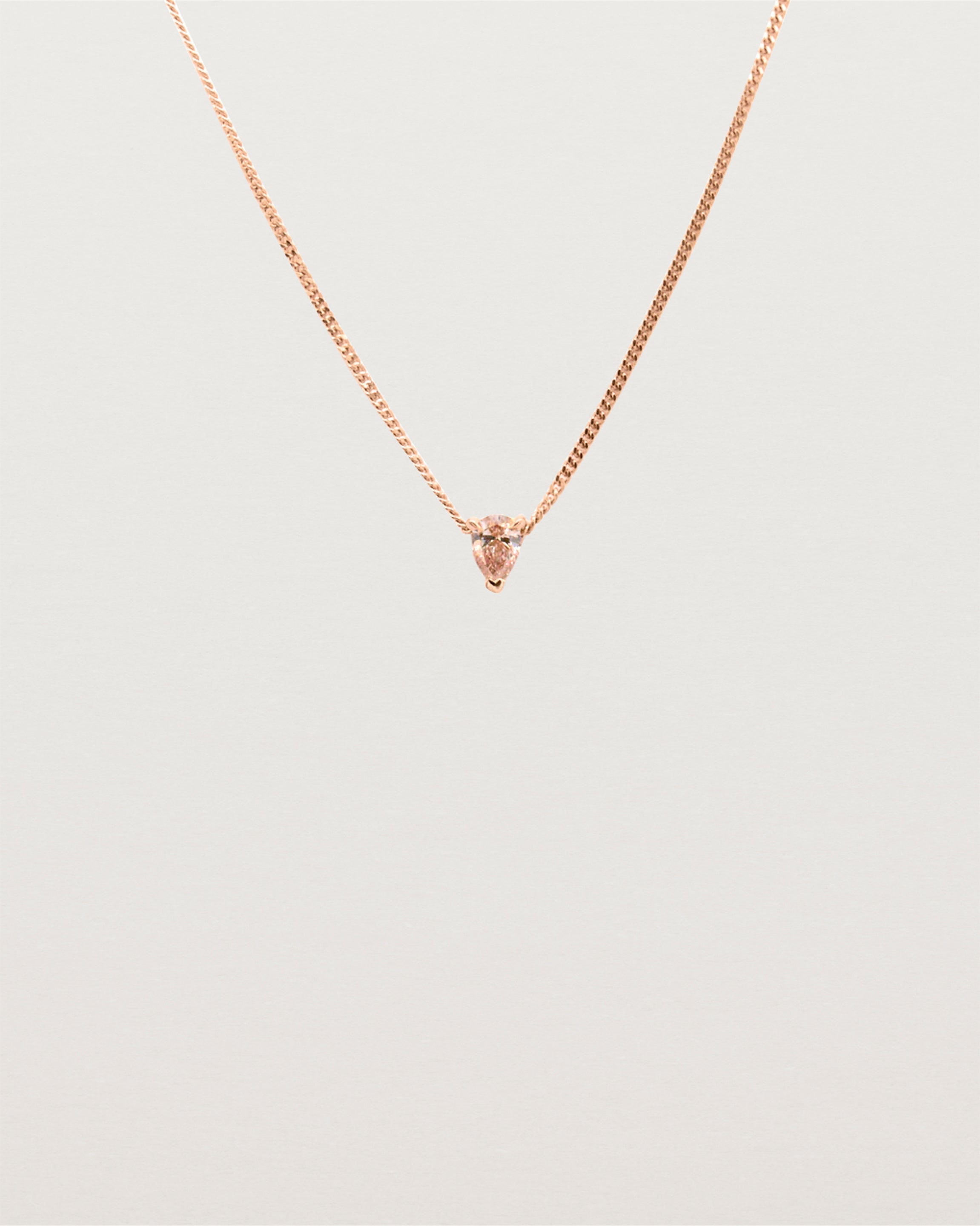 A necklace with a stunning 0.15ct pear cut pink diamond in a fine three claw pendant setting.