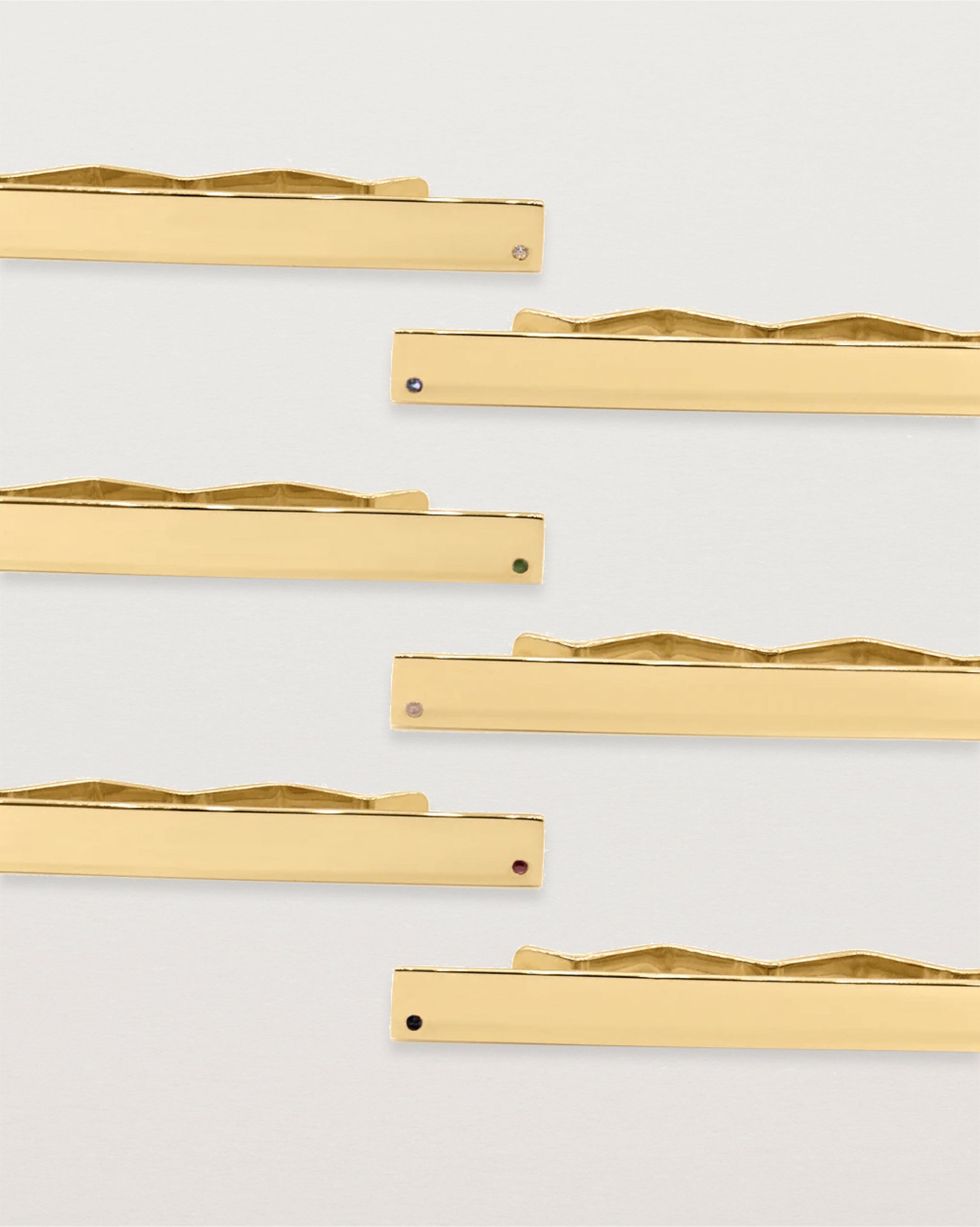 Five yellow gold rectangular tie bars