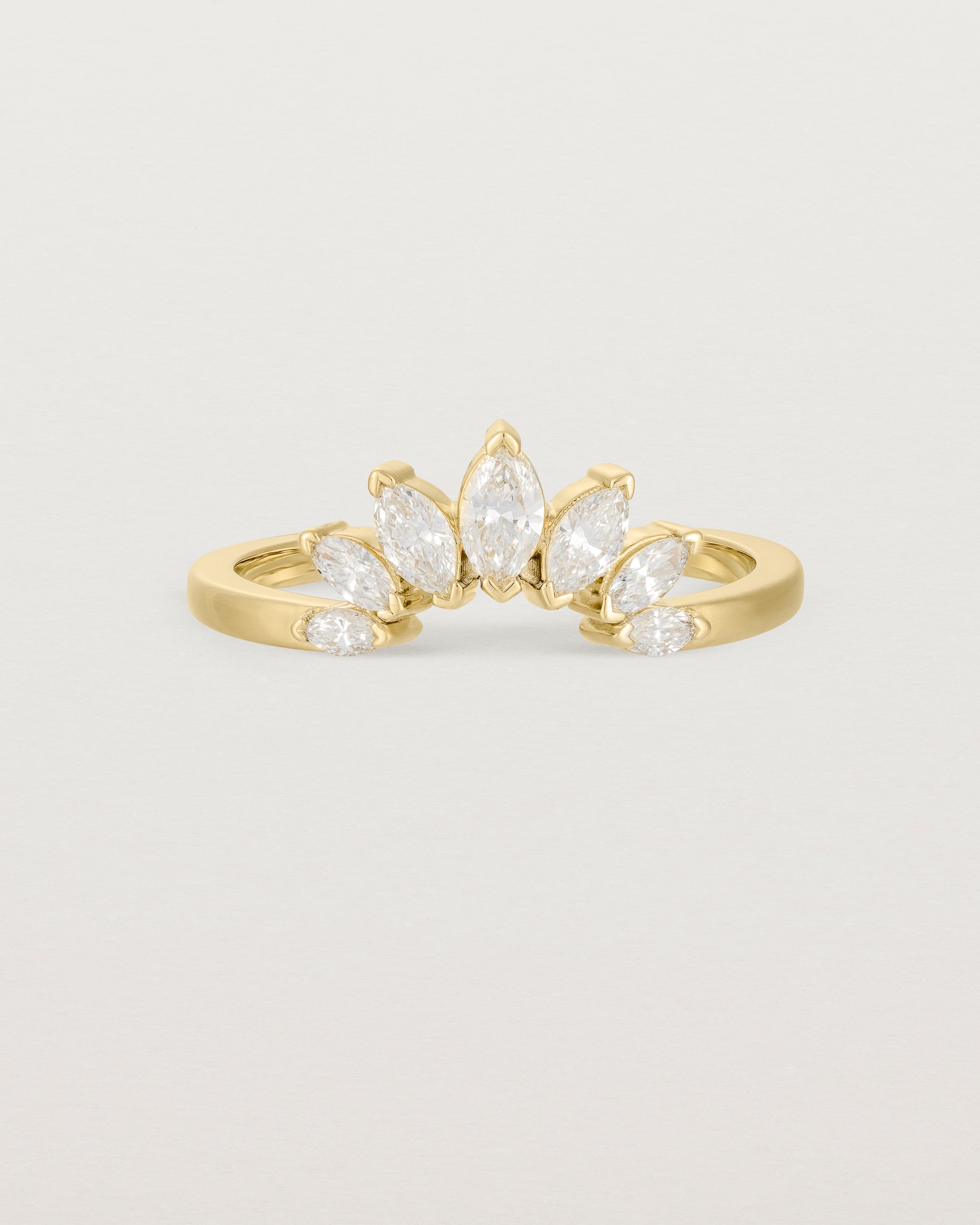 A white diamond, sun-beam inspired crown ring crafted in yellow gold
