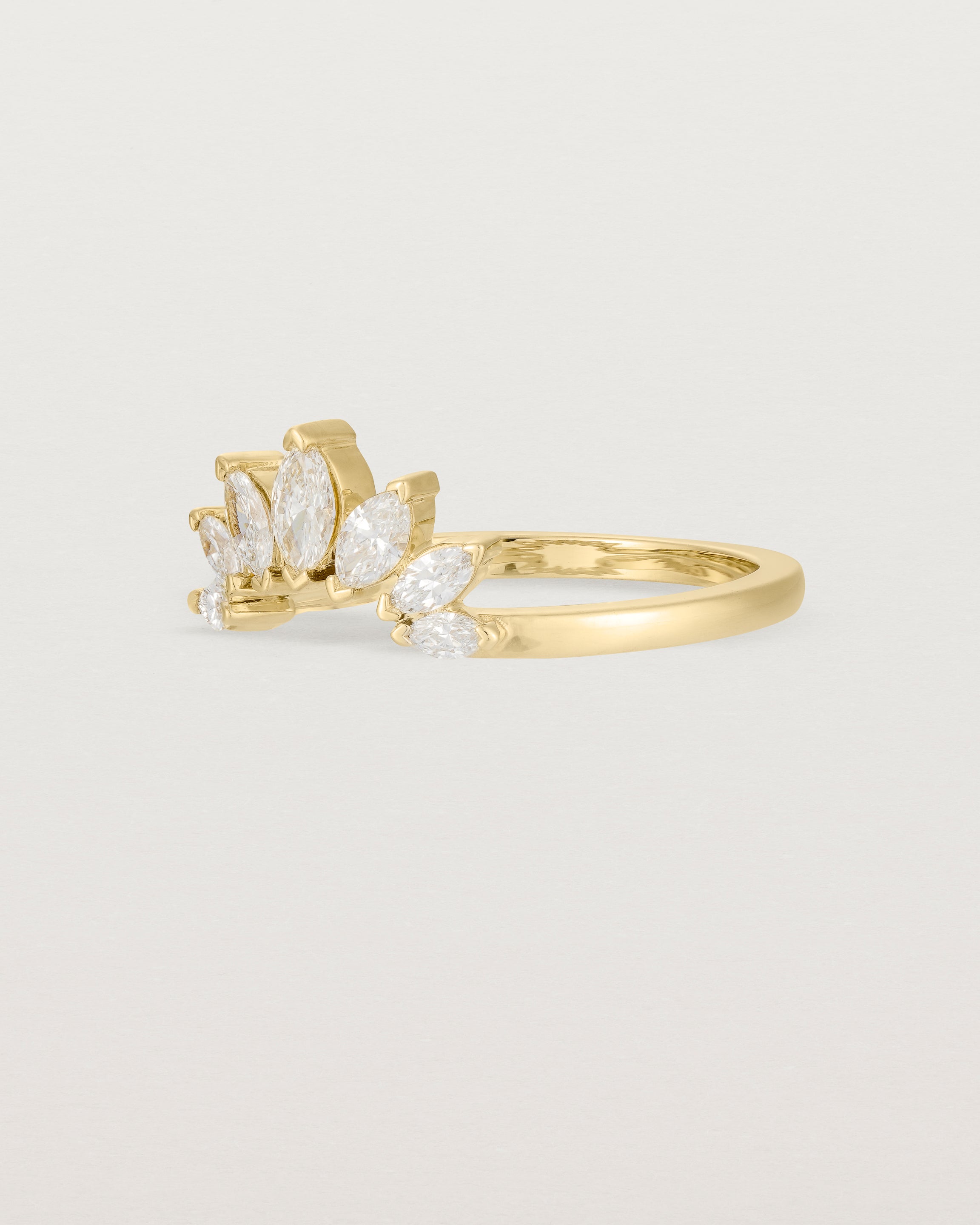A white diamond, sun-beam inspired crown ring crafted in yellow gold