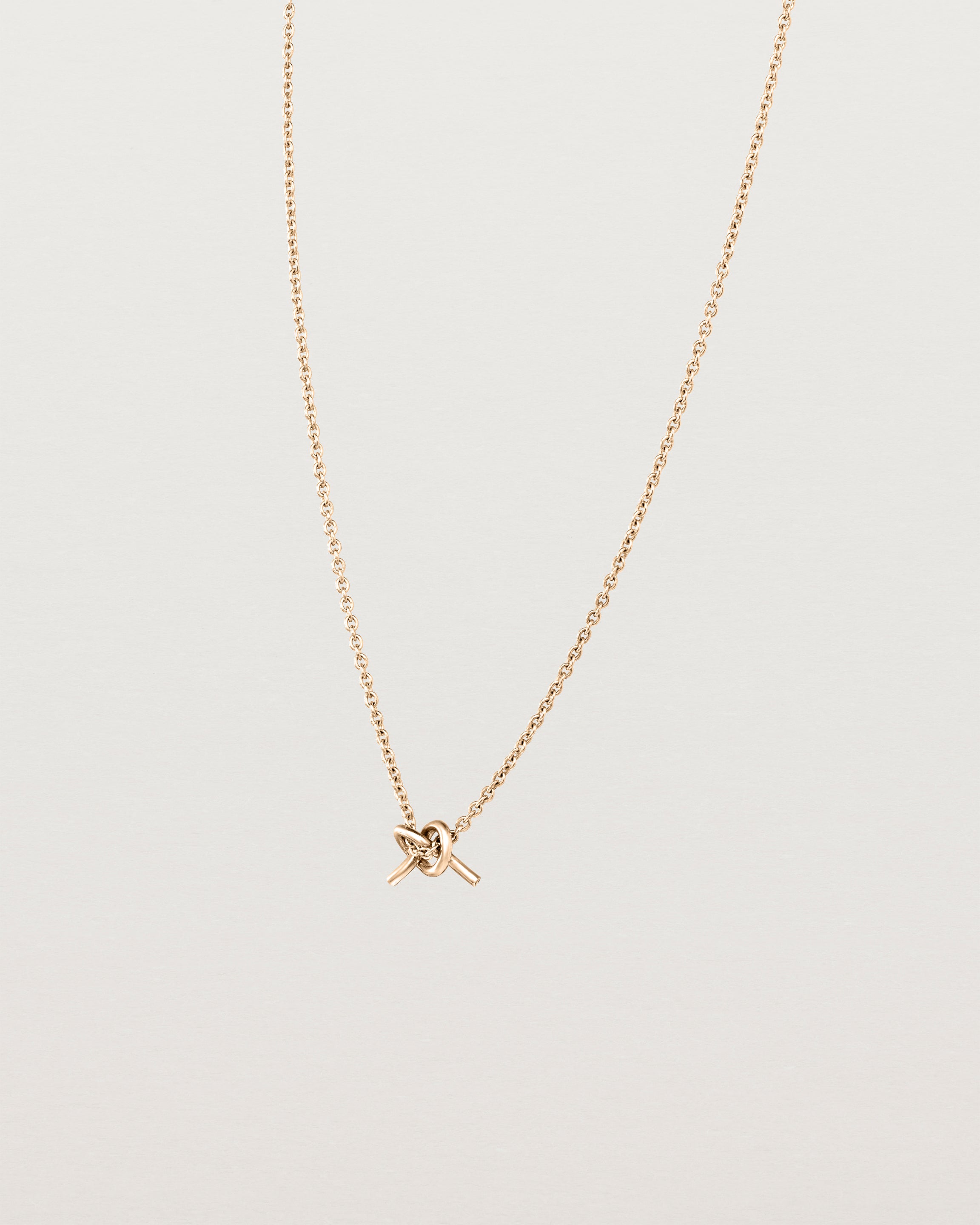 Angled view of the Cara Necklace in rose gold.