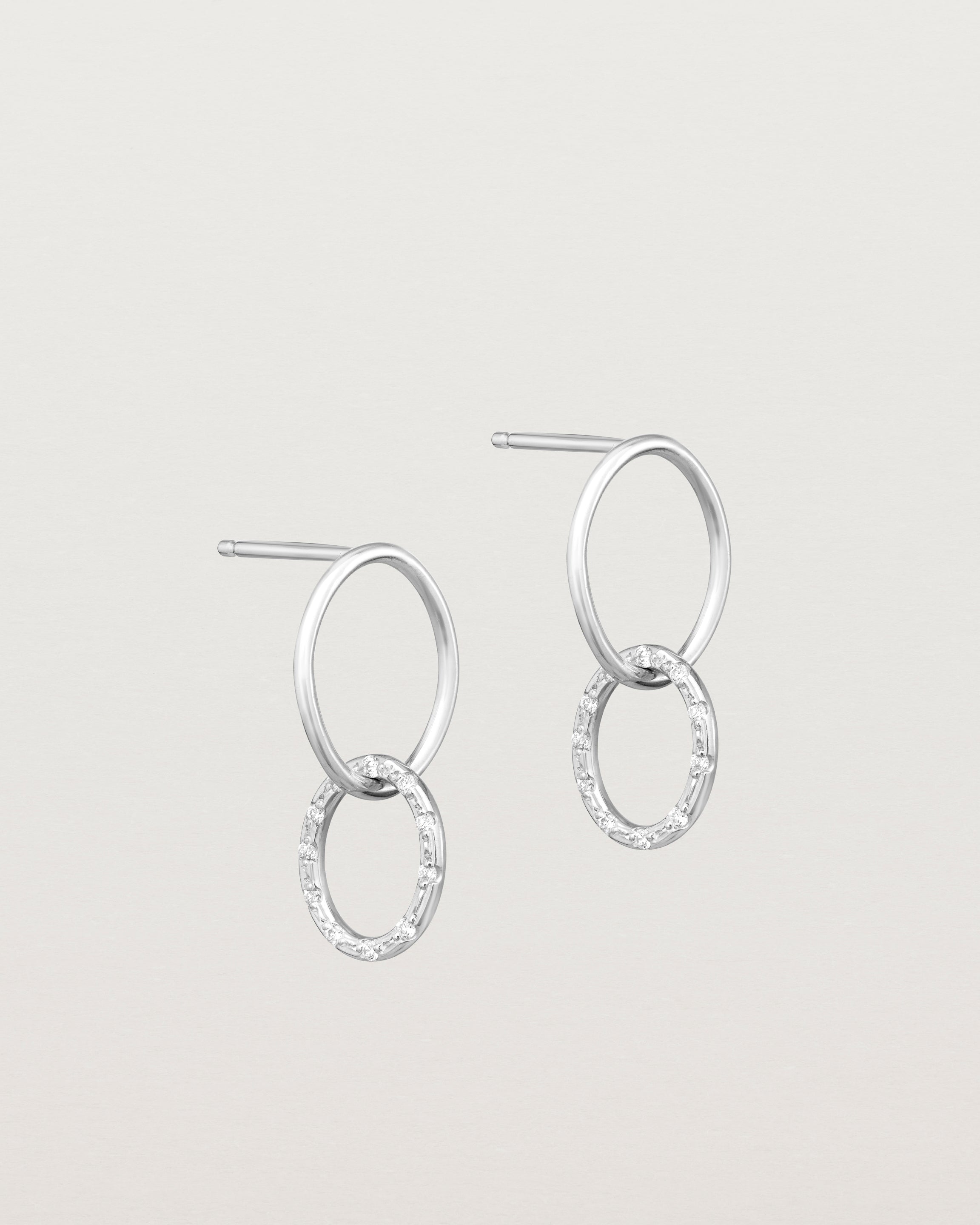 Angled view of the Cascade Loop Through Oval Studs | Diamonds in white gold.