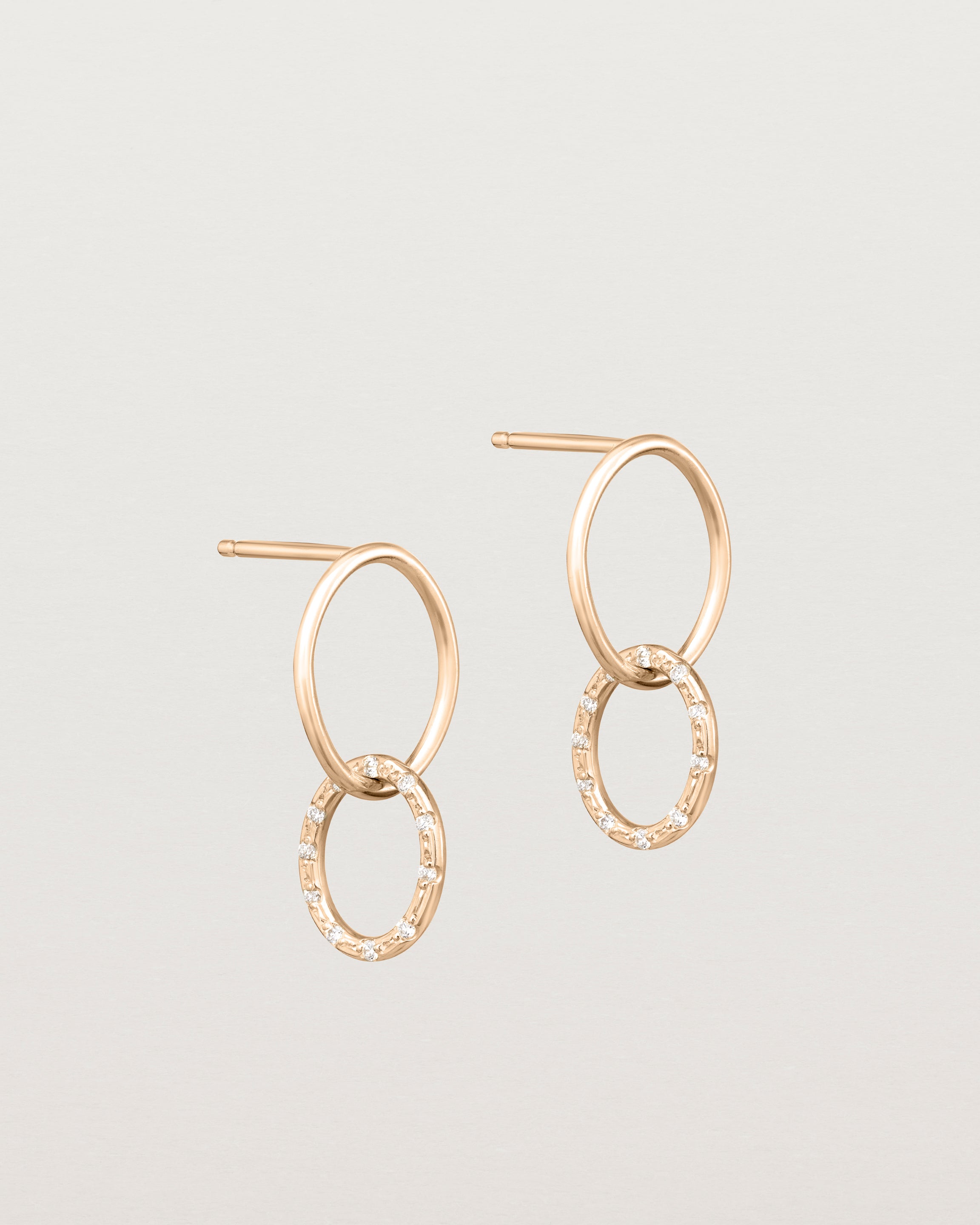 Angled view of the Cascade Loop Through Oval Studs | Diamonds in rose gold.
