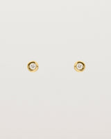 A small white circular yellow gold stud featuring a white diamond