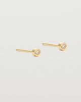 A small white circular yellow gold stud featuring a white diamond