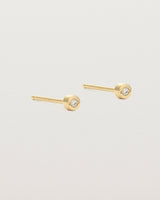 A small white circular yellow gold stud featuring a white diamond