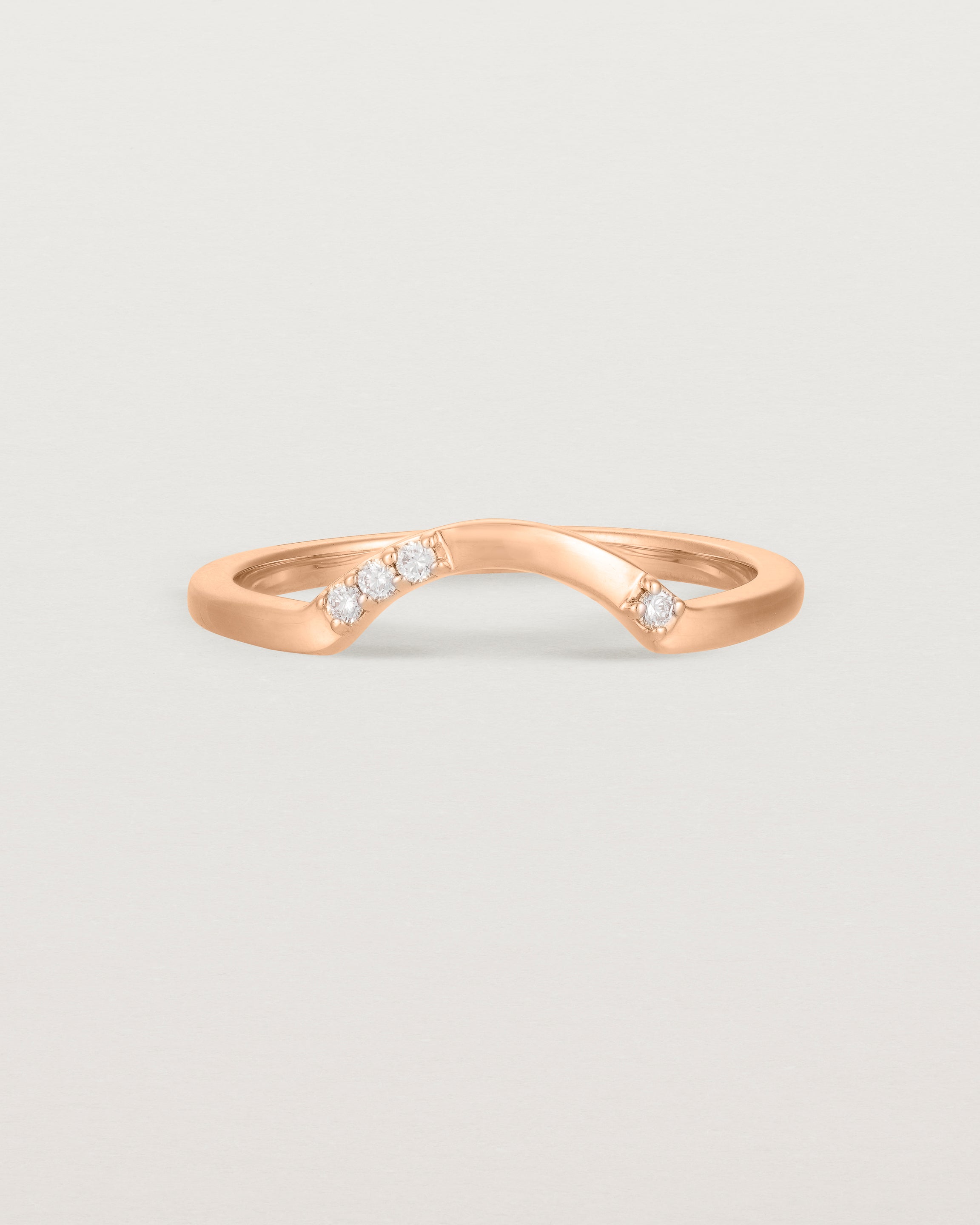 Fit three of a classic arc ring featuring scattered white diamonds, crafted in rose gold