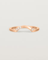 Fit three of a classic arc ring featuring scattered white diamonds, crafted in rose gold
