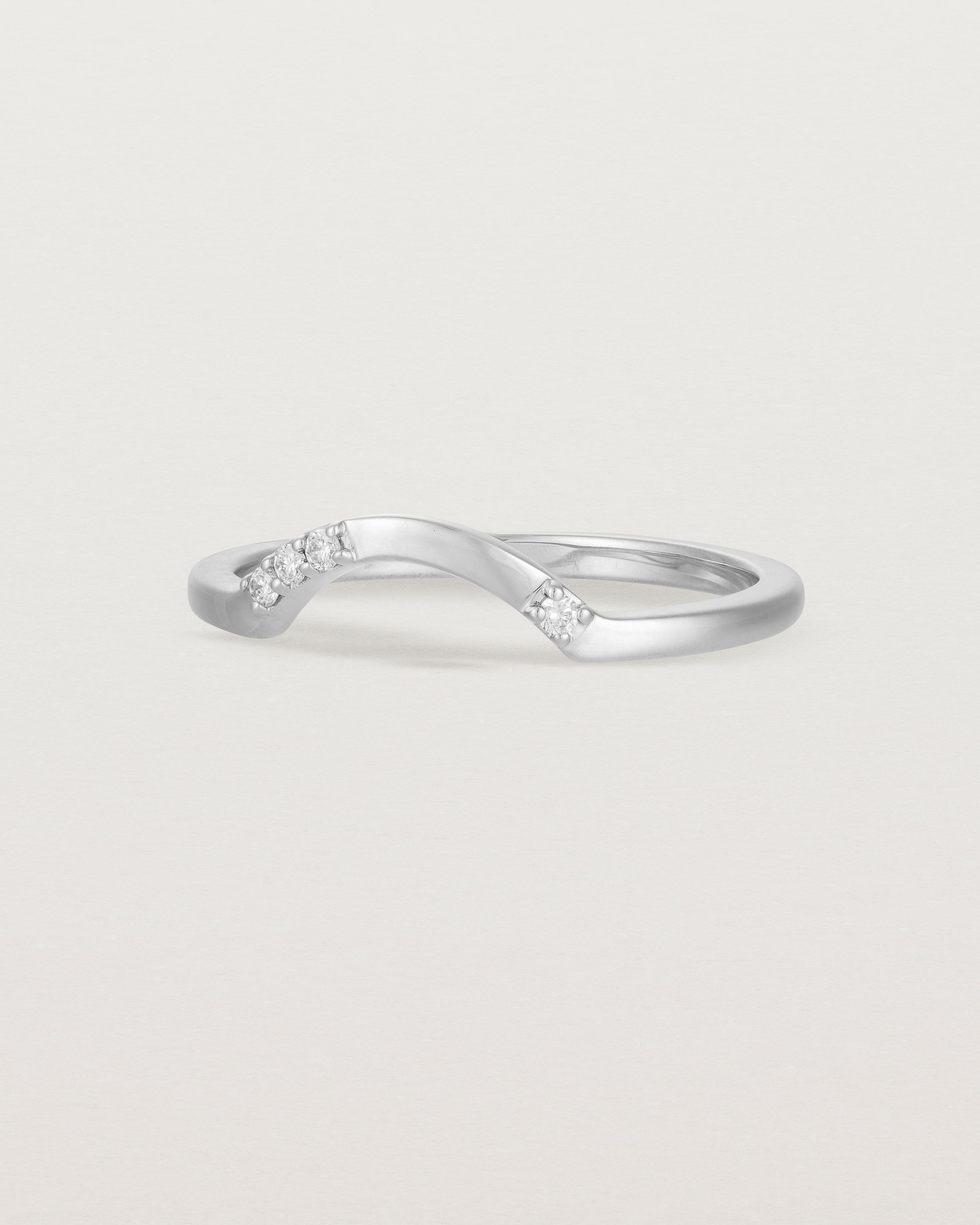 Fit three of a classic arc crown ring featuring scattered white diamonds, crafted in white gold