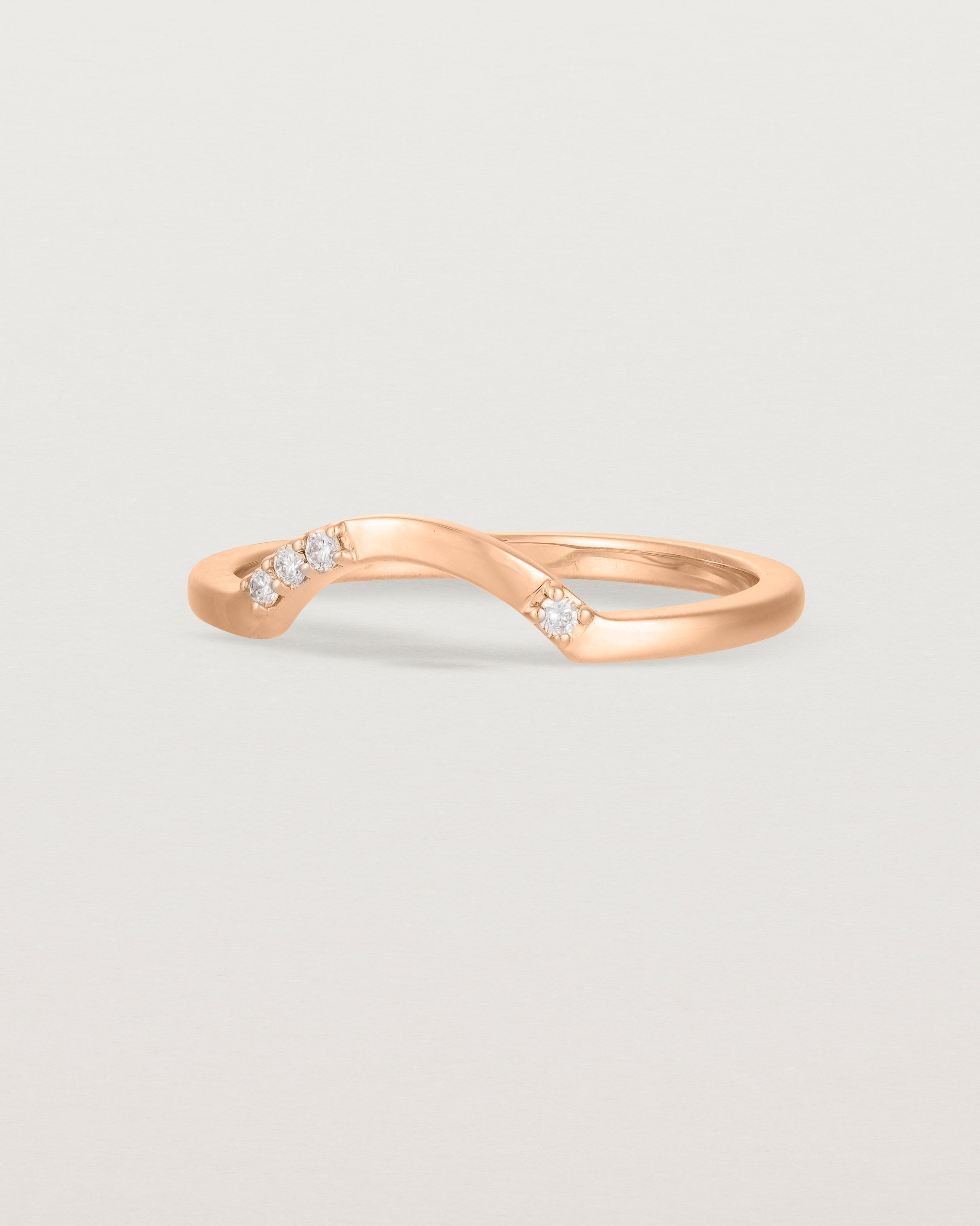 Fit three of a classic arc ring featuring scattered white diamonds, crafted in rose gold