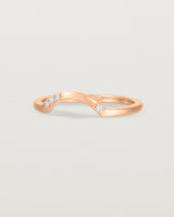 Fit three of a classic arc ring featuring scattered white diamonds, crafted in rose gold