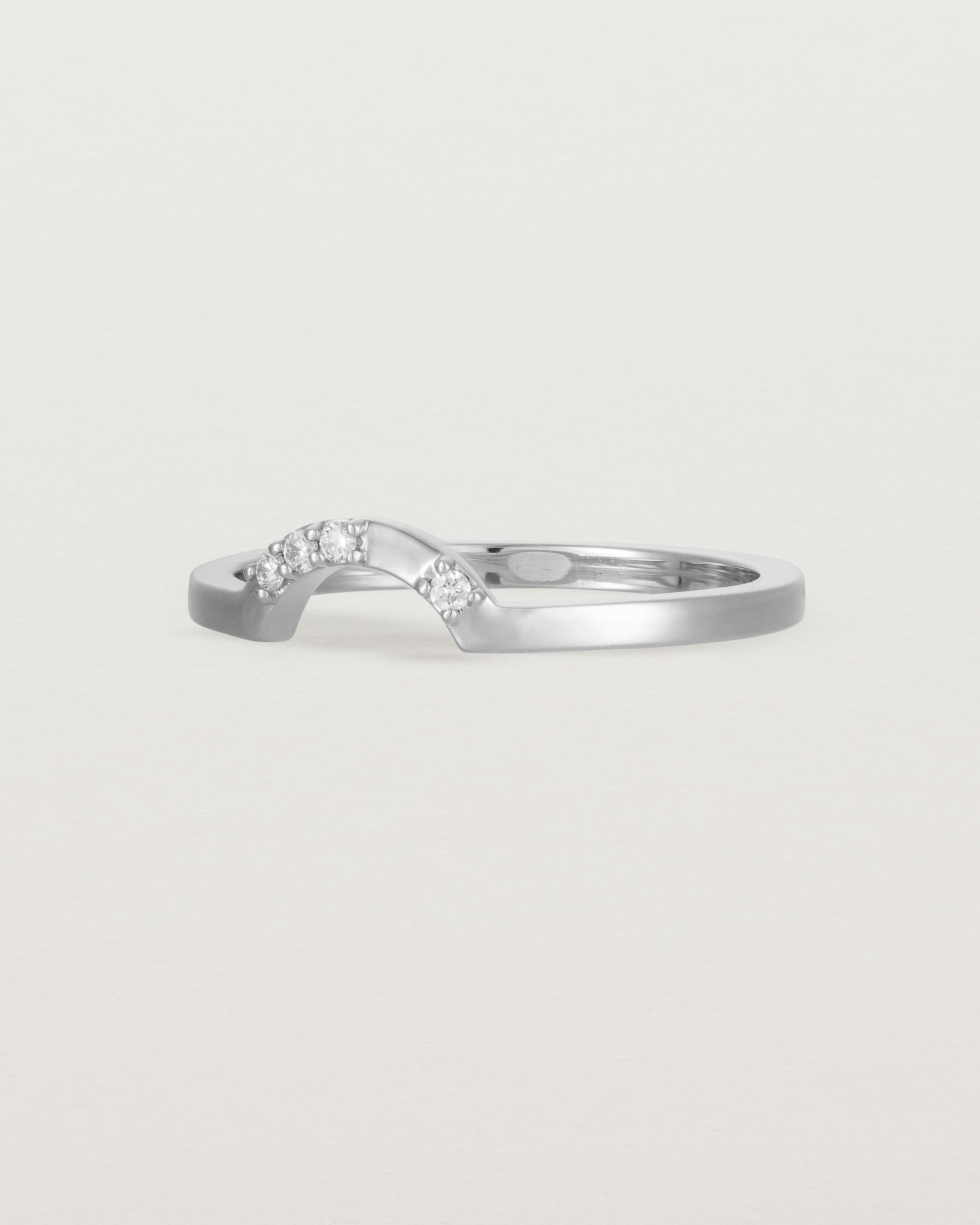 A classic small arc crown ring featuring scattered white diamonds, crafted in white gold
