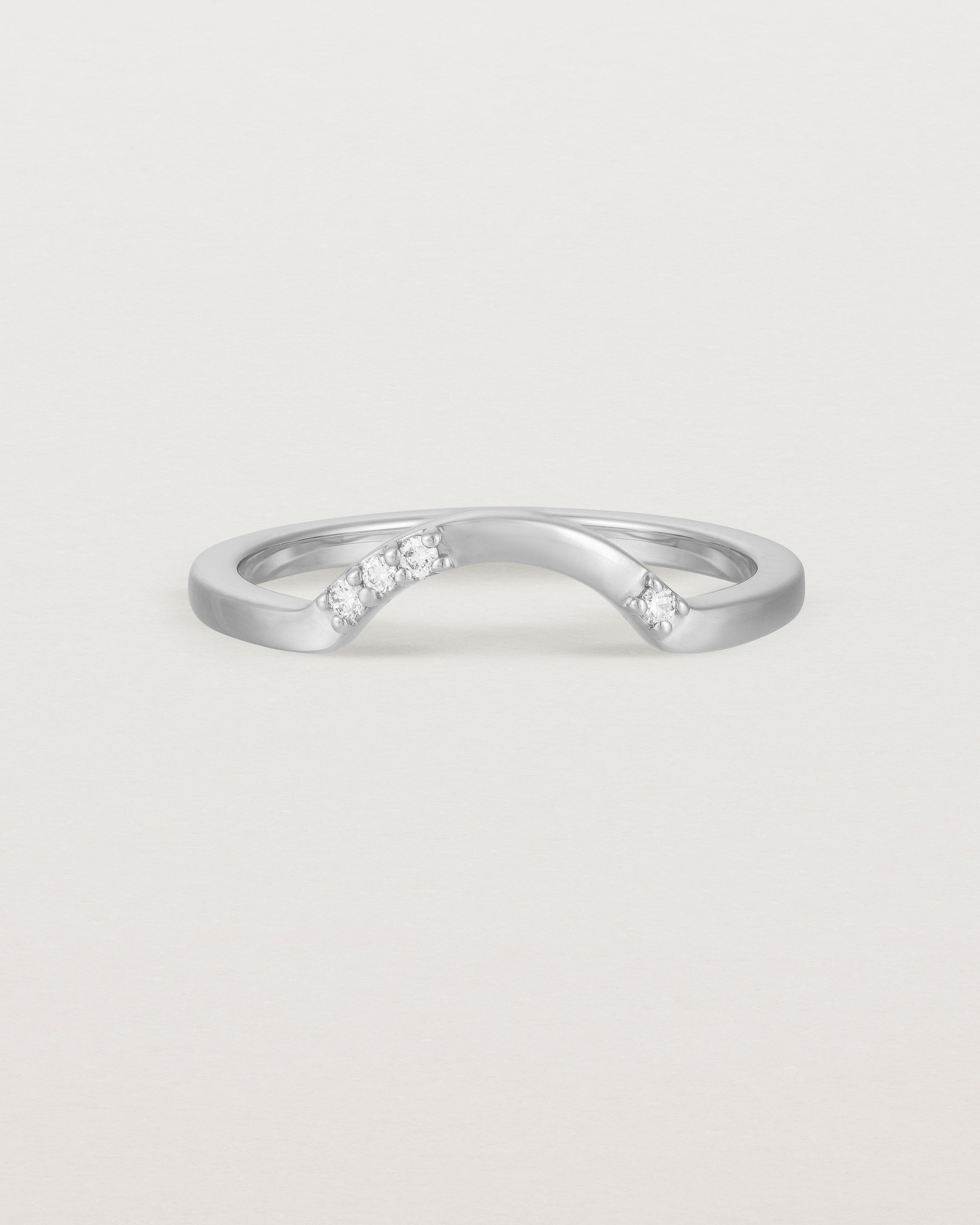 Fit four of a classic arc crown ring featuring scattered white diamonds, crafted in white gold
