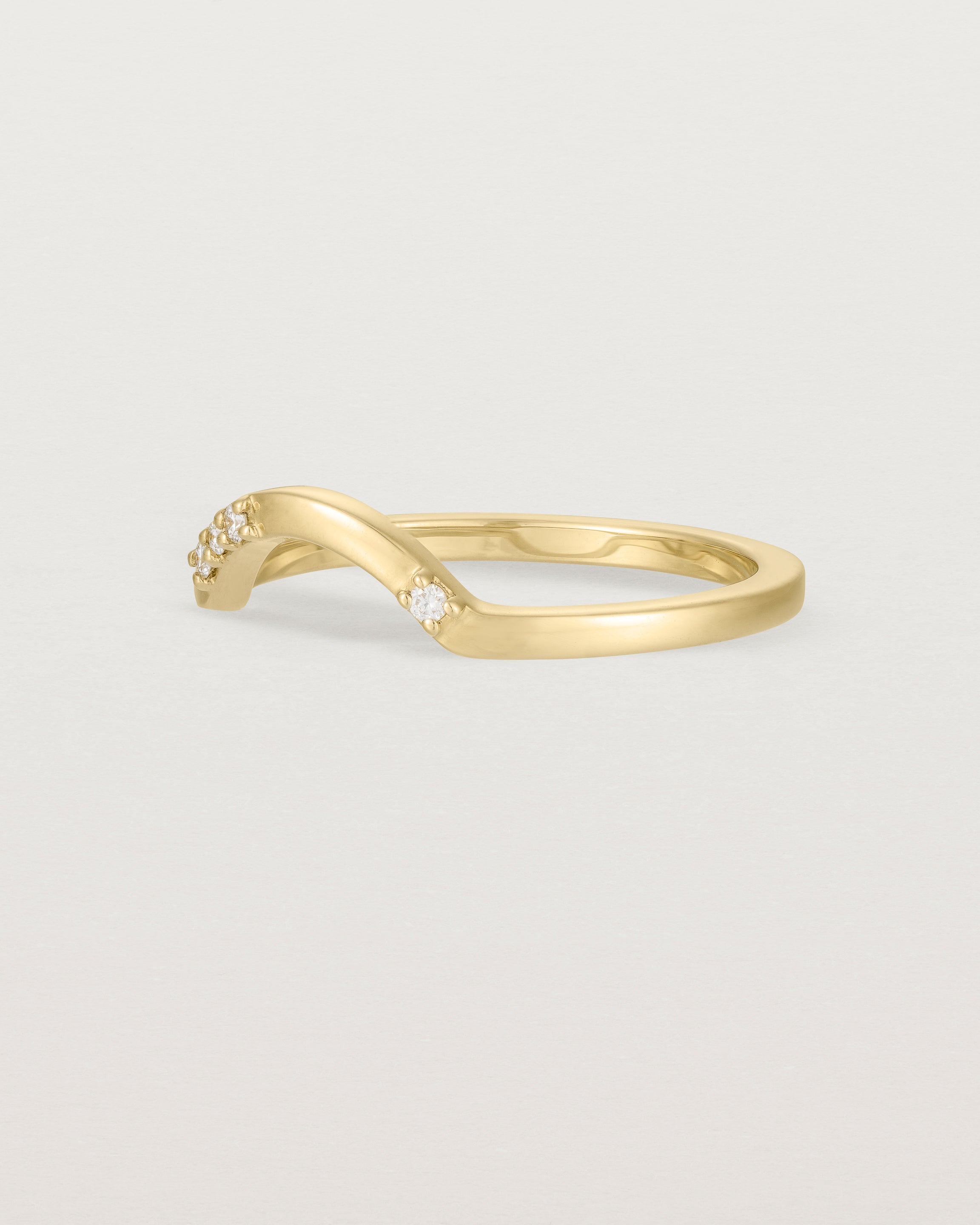 Fit four of a classic arc crown ring featuring scattered white diamonds, crafted in yellow gold