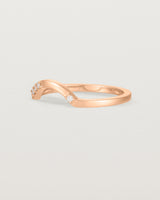 Fit four of a classic arc crown ring featuring scattered white diamonds, crafted in rose gold