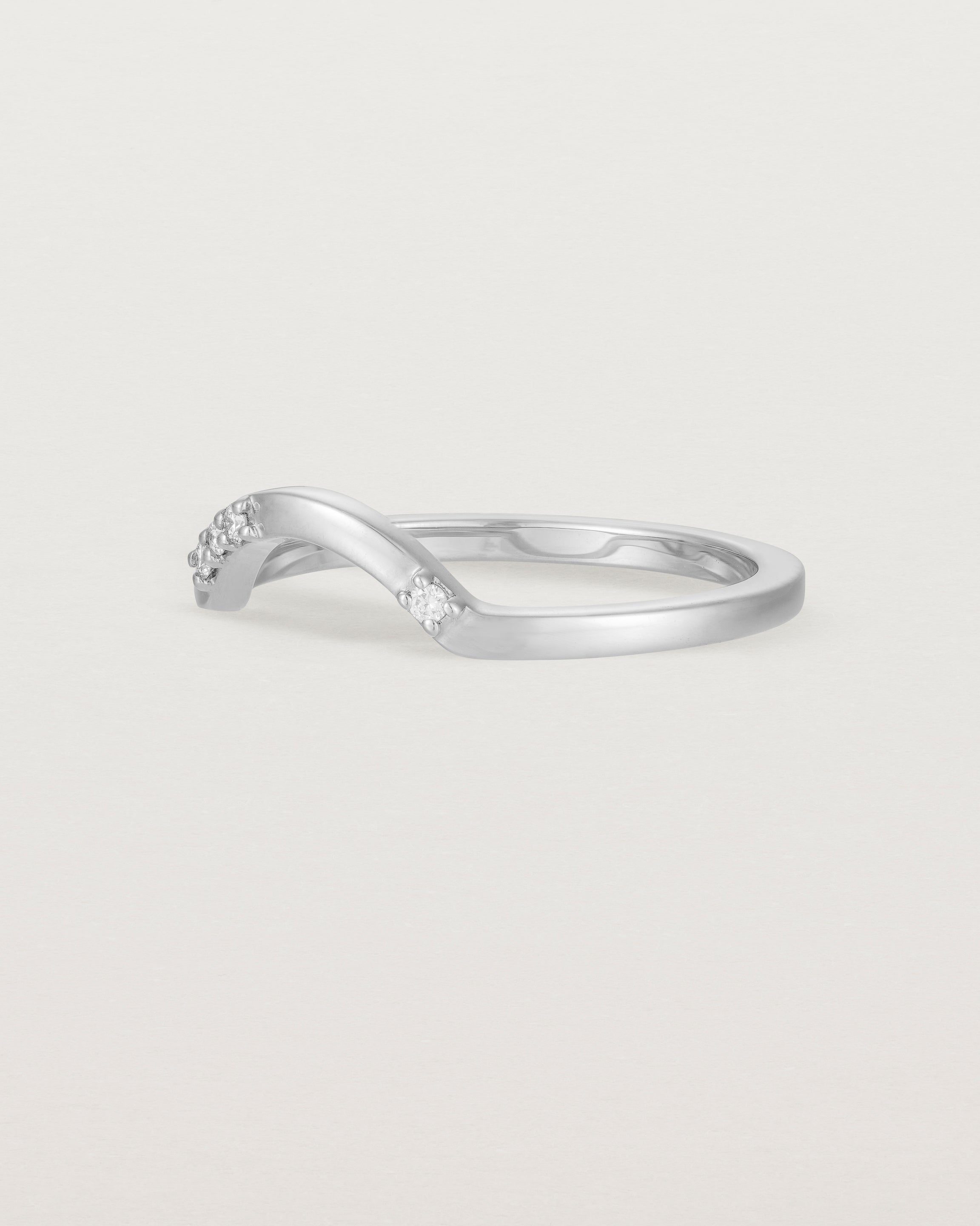 Fit four of a classic arc crown ring featuring scattered white diamonds, crafted in white gold