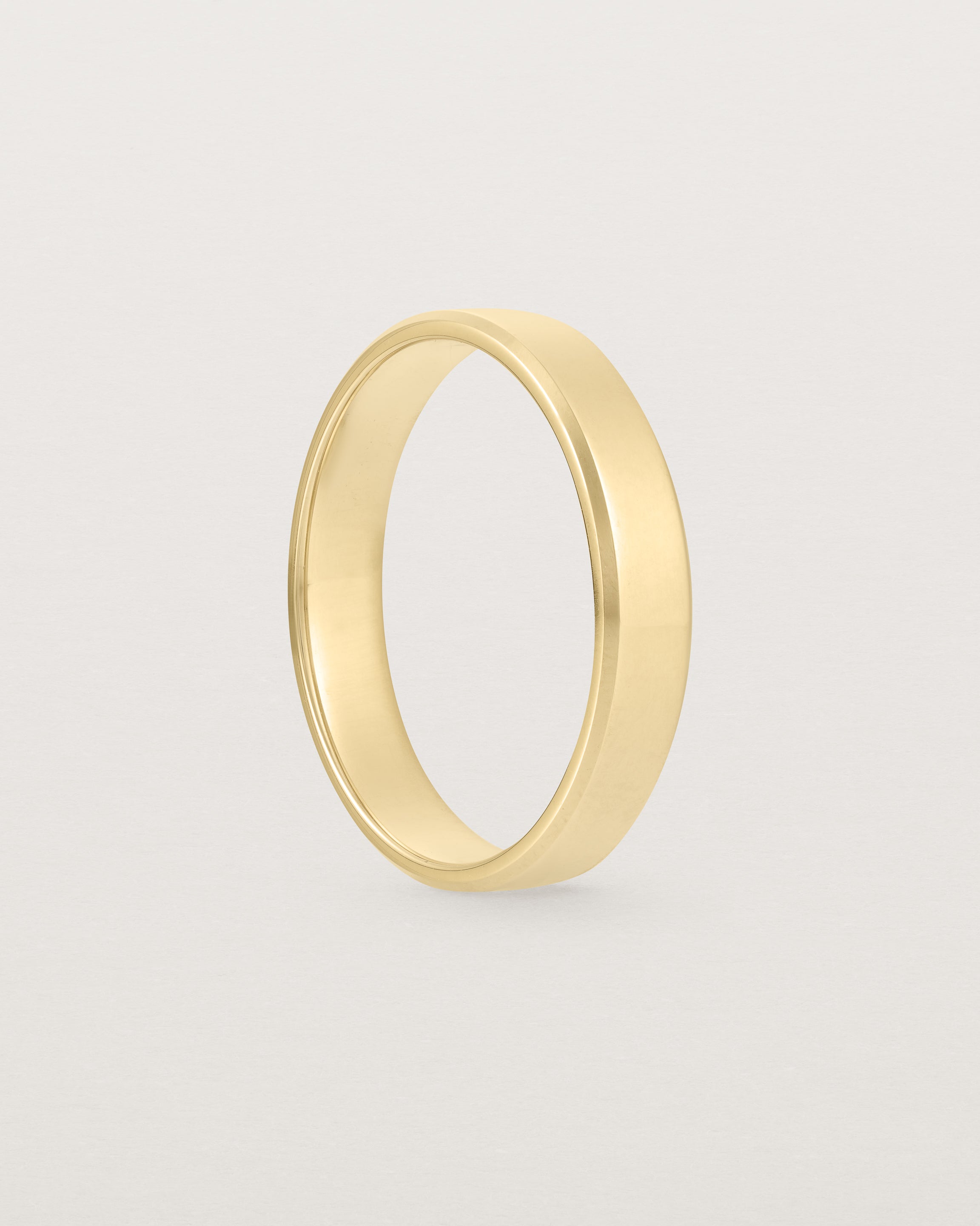 4mm yellow gold wedding band with a chamfered edge