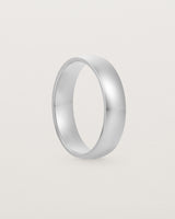 The front view of a 5mm wide heavy wedding ring in white gold. 