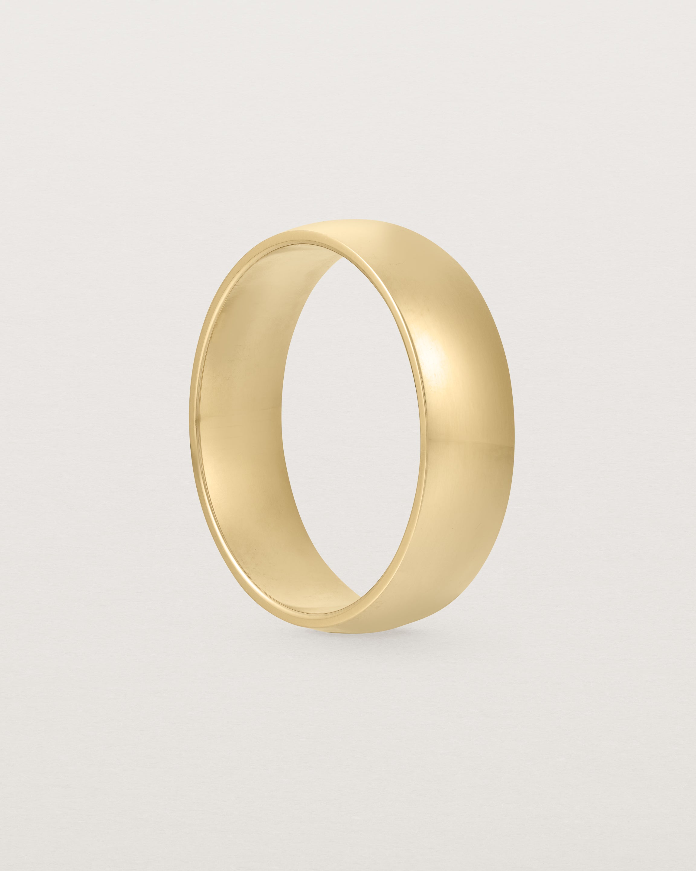 The side view of a heavy 6mm wedding band in yellow gold