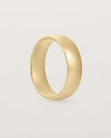 The side view of a heavy 6mm wedding band in yellow gold