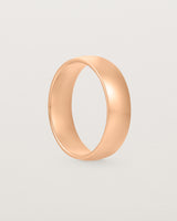 The front view of a 6mm wide heavy wedding ring in rose gold.