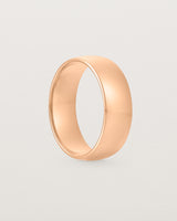 The side view of a heavy 7mm wedding band in rose gold